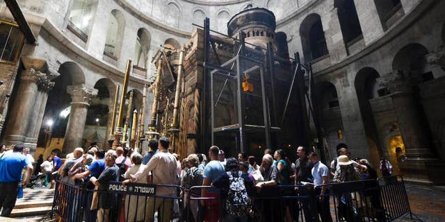 Christian pilgrims wait in line to visit the tomb of Jesus Christ in the Church of Holy Sepulcher in Jerusalem Friday, May 20, 2016. Christian officials have launched historic restoration work at the Tomb of Jesus inside the Church of Holy Sepulcher, site where tradition holds Jesus was crucified, buried and resurrected. The works are the first in almost two centuries that will focus on repairing, reinforcing and conserving the structure. (AP Photo/Mahmoud Illean)