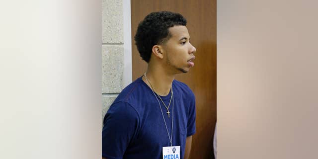 Philadelphia 76ers guard Michael Carter-Williams watches an NBA summer league basketball game between the Indiana Pacers and the Oklahoma City Thunder in Orlando, Fla., Wednesday, July 9, 2014. (AP Photo/John Raoux)