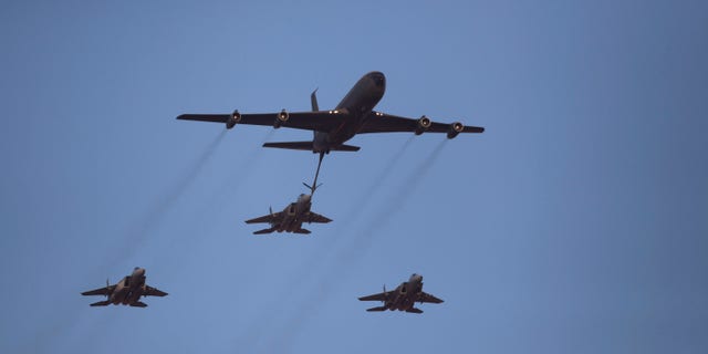 File - In this June 27, 2013 file photo, an Israeli Air Force Boeing 707 refuels three F15I fighter jets during an acrobatics display during a graduation ceremony in the Hatzerim air force base near the southern city of Beersheba, Israel. In an apparent message to Iran, the Israeli military said Thursday, Oct. 10, 2013, it had carried out a “special long-range flight exercise”. The military said its squadrons practiced refueling planes in midair this week and tested the air force’s ability. The accompanying footage shows a tanker plane refueling a fighter jet midair, a key part of any long-range operation. (AP Photo/Ariel Schalit, File)