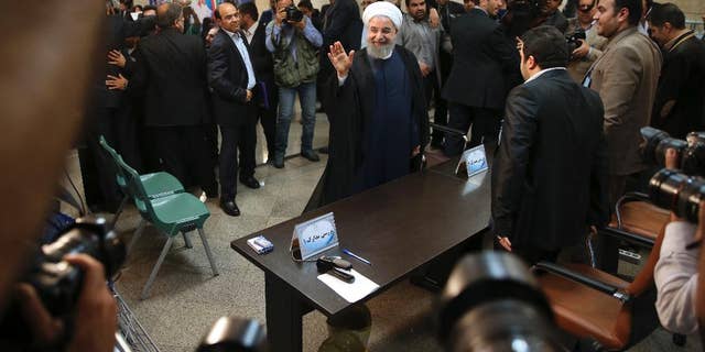 Iranian President Hassan Rouhani waves to media as he arrives at the Interior Ministry to register his candidacy for the May 19 presidential elections, in Tehran, Iran, Friday, April 14, 2017. (AP Photo/Vahid Salemi)