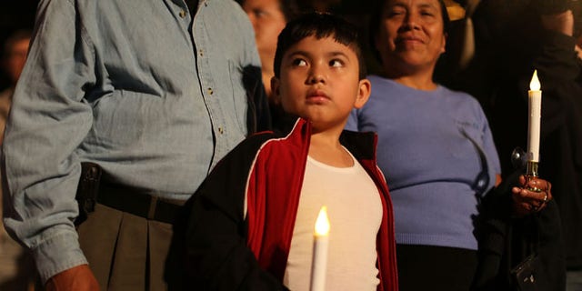 HOMESTEAD, FL - JANUARY 06:  Rodrigo Hernandez, whose family is originally from Guatemala, attends a vigil with his family to protest against the deportation of undocumented immigrants on January 6, 2016 in Homestead, Florida. President Barack Obama's administration has begun a series of large-scale raids against hundreds of undocumented immigrants across the US, which is generating outrage among pro-immigrant groups who reject the measure.  (Photo by Joe Raedle/Getty Images)