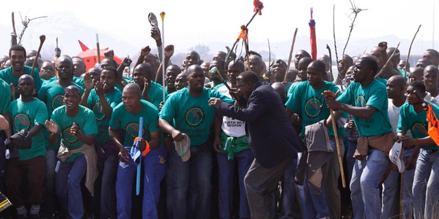 August 23, 2012: Mourners make their way to a memorial service at the Lonmin Platinum Mine near Rustenburg, South Africa after police shot and killed 34 striking miners and wounded 78 last week.