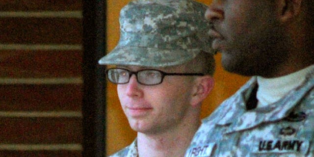 Dec. 17, 2011: Army Pfc. Bradley Manning, right, is escorted into a courthouse in Fort Meade, Md.