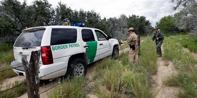 FILE PHOTO: A U.S. Customs and Border Protection Air and Marine agents and U.S. Customs and Border Protection agents compare notes as they patrol near the Texas-Mexico border, near McAllen, Texas. 