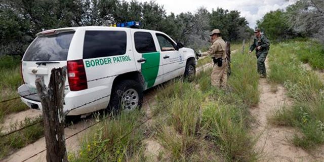 FILE PHOTO: A U.S. Customs and Border Protection Air and Marine agents and U.S. Customs and Border Protection agents compare notes as they patrol near the Texas-Mexico border, near McAllen, Texas.
