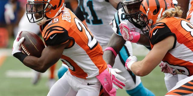 Cincinnati Bengals running back Giovani Bernard (25) breaks thru the line on his way to an 89-yard touchdown run against the Carolina Panthers in the first half of an NFL football game, Sunday, Oct. 12, 2014, in Cincinnati. (AP Photo/AJ Mast)