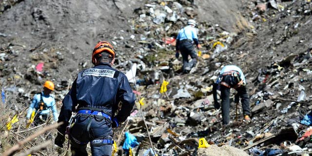In this undated photo provided by the French Interior Ministry, French emergency rescue services work at the site of the Germanwings jet that crashed on Tuesday, March 24, 2015 near Seyne-les-Alpes, France. The co-pilot of the Germanwings jet barricaded himself in the cockpit and intentionally rammed the plane full speed into the French Alps, ignoring the captain's frantic pounding on the door and the screams of terror from passengers, a prosecutor said Thursday. (AP Photo/French Interior Ministry, Francis Pellier)