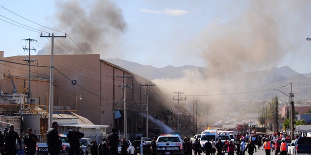 Police and rescue workers gather at a candy factory after an explosion in Ciudad Juarez, Mexico, Thursday, Oct. 24, 2013. The explosion happened at the Dulces Blueberry factory and caused the floor to collapse, said factory worker Ismael Bouchet. (AP Photo/Raymundo Ruiz)