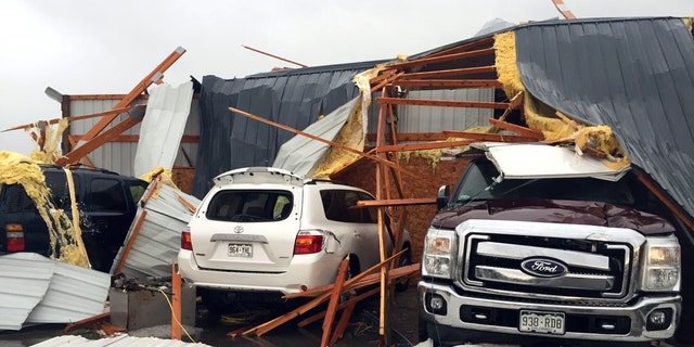 Debris lies on damaged vehicles after a tornado was reported in Weld County outside Wiggins, Colo., Saturday, May 7, 2016. Spring storms menaced parts of the West on Saturday, bringing hail and a tornado sighting in Colorado and deadly driving conditions in Arizona. (Kristen Skovira/KMGH-Channel 7 via AP) MANDATORY CREDIT