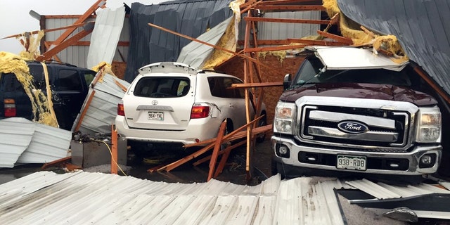 Debris lies on damaged vehicles after a tornado was reported in Weld County outside Wiggins, Colo., Saturday, May 7, 2016. Spring storms menaced parts of the West on Saturday, bringing hail and a tornado sighting in Colorado and deadly driving conditions in Arizona. (Kristen Skovira/KMGH-Channel 7 via AP) MANDATORY CREDIT