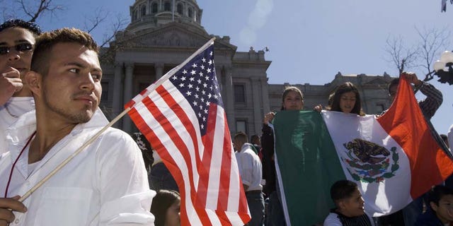 DENVER - APRIL 19:  Adrian Campos, 16, holds a U.S. flag during a rally with about 3,000 middle and high school students who walked out of school April 19, 2006 in Denver, Colorado. The students gathered on the steps of the Colorado state Capitol to demonstrate in support of immigrant rights and against U.S. Congressional immigration reform proposals.  (Photo by Kevin Moloney/Getty Images)
