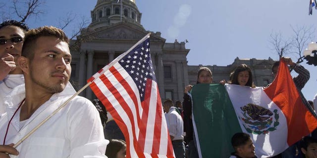DENVER - APRIL 19: Adrian Campos, 16, holds a U.S. flag during a rally with about 3,000 middle and high school students who walked out of school April 19, 2006 in Denver, Colorado. The students gathered on the steps of the Colorado state Capitol to demonstrate in support of immigrant rights and against U.S. Congressional immigration reform proposals. (Photo by Kevin Moloney/Getty Images)