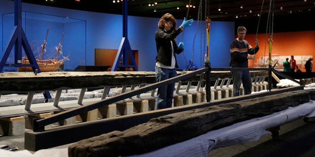 In this Oct. 22, 2014 photo work to reassemble the 54-foot oak French frigate La Belle begins at the Bullock Texas State History Museum in Austin, Texas. Archaeologists are beginning to reassemble the remains of the ship recovered more than 300 years after the vessel was lost in a storm off the coast of Texas. (AP Photo/Eric Gay)