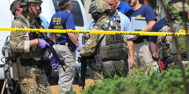 FBI, Orlando Police and personnel from the Orange County Sheriff's Office investigate the attack at the Pulse nightclub on June 12.