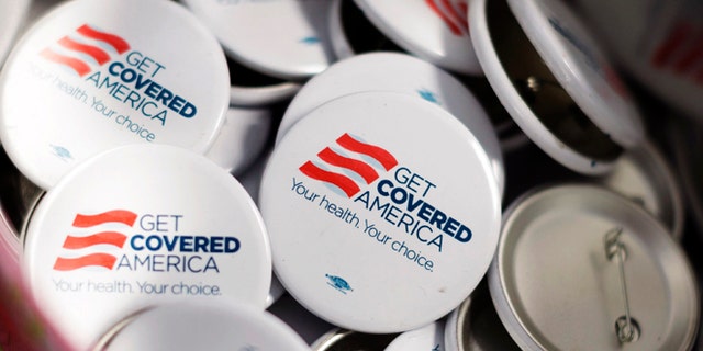 Get Covered America buttons are seen during a training session in Chicago, Illinois September 7, 2013 before volunteers canvas a Chicago neighborhood to talk with residents about the Affordable Care Act - also known as Obamacare.