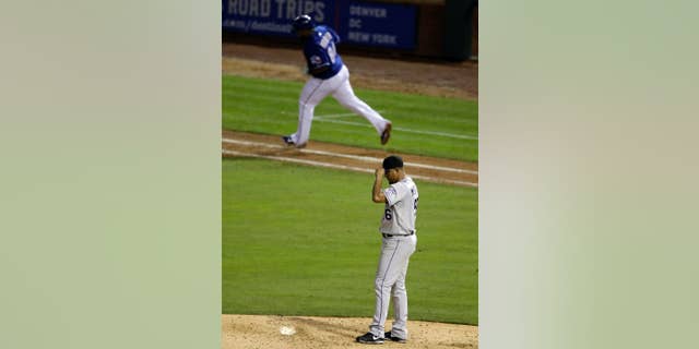 Colorado Rockies starting pitcher Franklin Morales (56) lowers the bill of his cap over his face as Texas Rangers' Prince Fielder rounds first on a solo home run off of Morales in the sixth inning of a baseball game, Thursday, May 8, 2014, in Arlington, Texas. The Rangers won 5-0. (AP Photo/Tony Gutierrez)
