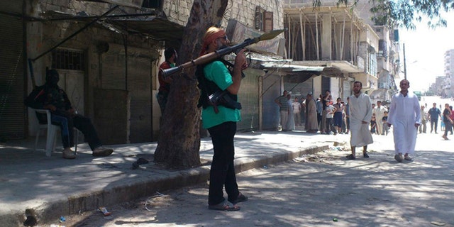 July 20: Members of the Free Syrian Army patrol in Sukari, Aleppo province.