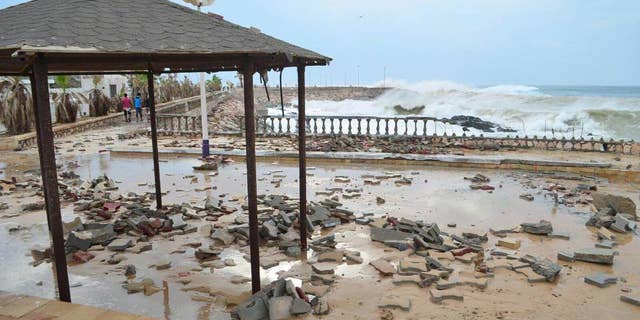 FILE - In this Monday, Nov. 2, 2015 file photo, A tropical Cyclone Chapala batters Mukalla, Yemen. Yemen's Islamic State affiliate claimed responsibility for a suicide car bombing that struck a coast guard base in the southern port city of Mukalla at dawn Thursday, May 12, 2016 killing at least six troops in the first major attack in a city once occupied by its rival group, al-Qaida. (AP Photo/Mohammed Bazahier, File)