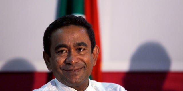 In this late Saturday, Nov. 16, 2013 photo, Maldives' Yaamin Abdul Gayoom, brother of former autocrat Maumoon Abdul Gayoom smiles during a press conference in Male, Maldives. Voters in the Maldives have chosen the brother of the archipelago nation's former strongman to be their new president over the country's first democratically elected leader in a closely fought runoff election on Saturday. (AP Photo/Sinan Hussain)