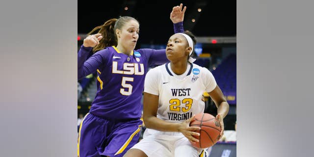 West Virginia guard Bria Holmes (23) looks for an opening to the goal as LSU guard Jeanne Kenney (5) defends in the first half of an NCAA college basketball second-round tournament game Tuesday, March 25, 2014, in Baton Rouge, La. (AP Photo/Rogelio V. Solis)