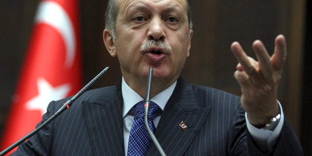 FILE - In this Tuesday, Nov. 26, 2013 file photo, Turkish Prime Minister Recep Tayyip Erdogan addresses lawmakers at the parliament in Ankara, Turkey. Prime Minister Recep Tayyip Erdogan, who has dominated Turkish politics for a decade, is entering election season on uncertain footing: without the support of key groups that had powered his previous electoral wins and facing divisions within his own party. (AP Photo, File)