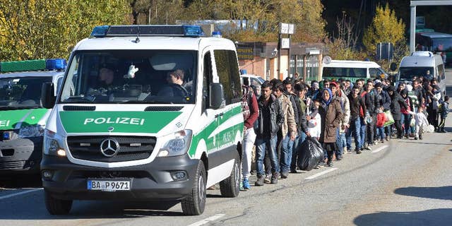 German federal police guide a group of migrants on their way.