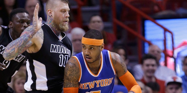 New York Knicks forward Carmelo Anthony (7) drives around Miami Heat forward Chris Andersen (11) during the first half of an NBA basketball game, Monday, Feb. 9, 2015, in Miami. (AP Photo/Wilfredo Lee),