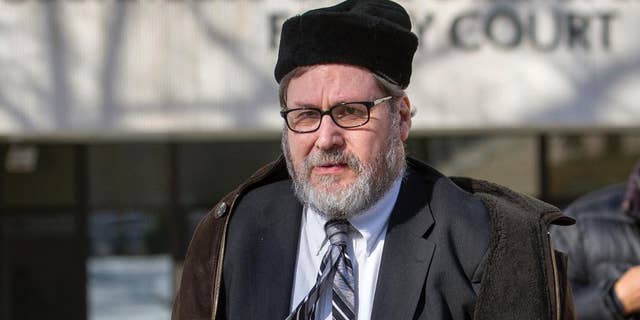 FILE - In this Feb. 19, 2015 file photo, Rabbi Bernard Freundel leaves the D.C. Superior Court House in Washington. Freundel, A once-prominent Orthodox rabbi who pleaded guilty to secretly videotaping nude women at a Jewish ritual bath in Washington was given a lawful sentence when he was sentenced to approximately 6 ½ years in prison, an appeals court ruled Thursday, Sept. 15, 2016. (AP Photo/Cliff Owen, File)