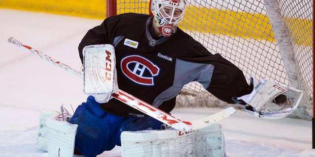 Montreal Canadiens goalie Dustin Tokarski makes a save during the team's practice Wednesday, May 21, 2014 in Brossard, Quebec. The Canadiens play the New York Rangers in Game 3 of the Eastern Conference final of the Stanley Cup Playoffs on Thursday in New York. (AP Photo/The Canadian Press, Ryan Remiorz)