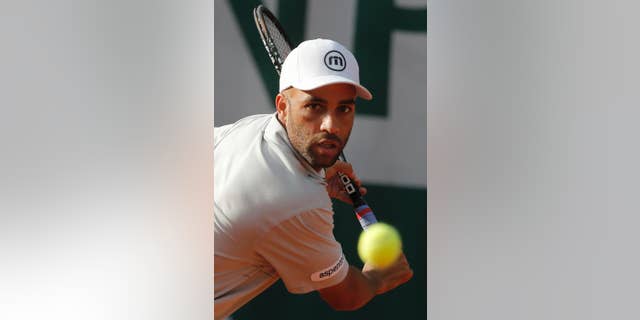 FILE - In this May 26, 2013, file photo, James Blake makes a return against Serbia's Viktor Troicki in their first round match of the French Open tennis tournament in Paris. New York City's police commissioner says he's been trying to apologize to former tennis professional James Blake, who was handcuffed by officers after a case of mistaken identity. Blake says he was standing outside a Manhattan hotel Wednesday, Sept. 9, 2015, waiting to head to the U.S. Open when an officer charging him. He says he was body-slammed and handcuffed. (AP Photo/Michel Spingler, File)