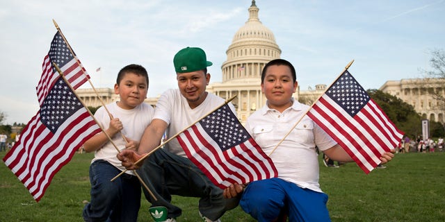 Josue Benavides, 28, center, who is originally from El Salvador, poses for a portrait with his cousins Jonathan, 7, left, and Christopher Benavides, 11, of Alexandria, Va., after attending the "Rally for Citizenship," a rally in support of immigration reform, on Capitol Hill in Washington, on Wednesday, April 10, 2013. Bipartisan groups in the House and Senate are said to be completing immigration bills that include a pathway to citizenship for the nation's 11 million immigrants with illegal status. "We need reform," says Josue Benavides, "so that the families can have a better life and avoid separations." (AP Photo/Jacquelyn Martin)