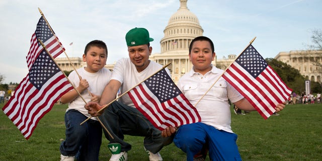 Josue Benavides, 28, center, who is originally from El Salvador, poses for a portrait with his cousins Jonathan, 7, left, and Christopher Benavides, 11, of Alexandria, Va., after attending the "Rally for Citizenship," a rally in support of immigration reform, on Capitol Hill in Washington, on Wednesday, April 10, 2013. Bipartisan groups in the House and Senate are said to be completing immigration bills that include a pathway to citizenship for the nation's 11 million immigrants with illegal status. "We need reform," says Josue Benavides, "so that the families can have a better life and avoid separations." (AP Photo/Jacquelyn Martin)