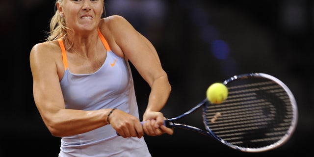 Russia's Maria Sharapova returns a shot to Serbia's Ana Ivanovic during their quarter final match at the Porsche tennis GP in Stuttgart, Germany, Friday, April 26, 2013. Sharapova won the match with 7-5,4-6 and 6-4. (AP Photo/dpa, Daniel Maurer)