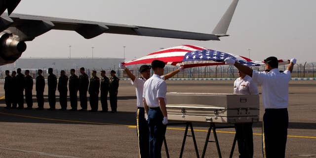 APRIL 13: U.S. military members pay final respects to what they believe may be the remains of one to two crew members from a B-24 bomber that crashed during World War II at a ceremony at the Palam airport.