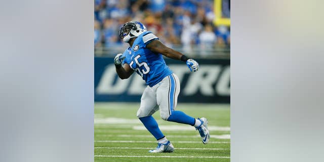 Detroit Lions middle linebacker Stephen Tulloch (55) celebrates his sack of Green Bay Packers quarterback Aaron Rodgers (12) during the first half of an NFL football game in Detroit, Sunday, Sept. 21, 2014. Tulloch injured his left knee celebrating. (AP Photo/Rick Osentoski)