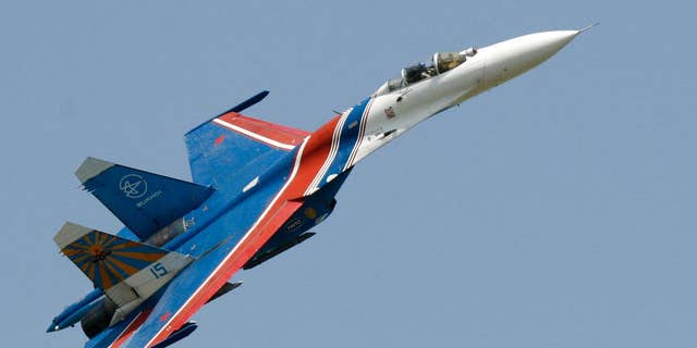 FILE- In this Saturday, May 26, 2007 file photo, a Sukhoi Su-27 fighter jet of the Russian air force elite aerobatic team Russkiye Vityazi (Russian Knights) makes a low pass during an air show in Rostov-on-Don, Russia. A pilot of the Russian air force's elite aerobatic squadron died Thursday, June 9, 2016 when his fighter jet crashed near Moscow. The Russian Defense Ministry said the Su-27 fighter jet went down while returning from a training mission. It said, according to preliminary information, the crash had been caused by a technical malfunction, but wouldn't elaborate pending an official probe. 3 (AP Photo/Sergei Venyavsky, file)