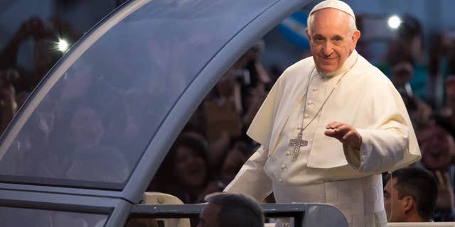 RIO DE JANEIRO, BRAZIL - JULY 26: Pope Francis waves from the Popemobile on his way to attend the Via Crucis on Copacabana Beach during World Youth Day celebrations on July 26, 2013 in Rio de Janeiro, Brazil. More than 1.5 million pilgrims are expected to join the pontiff for his visit to the Catholic Church's World Youth Day celebrations which is running July 23-28. (Photo by Buda Mendes/Getty Images)