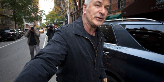 November 15, 2013. Actor Alec Baldwin shoves a photographer and tells him to move out of his way after he arrived in his SUV at the building where he lives in New York.