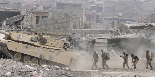 While under fire, “Monkey,” Mahmoud Darweesh, David Eubank, Sky Barkley, and Ephraim Mattos follow a single Iraqi tank toward ISIS lines to rescue stranded civilians. (June 2, 2017)