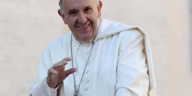FILE - In this Oct. 19, 2016, file photo, Pope Francis waves to the crowd as he is driven around St. Peter's Square ahead of his weekly general audience, at the Vatican. Francis was presented by Chicago Archbishop Blase Cupich with a Chicago Cubs hat and what looks like a signed baseball at the Vatican Tuesday, Nov. 15, 2016, nearly two weeks after the Cubs won their first World Series since 1908. (AP Photo/Alessandra Tarantino, File)