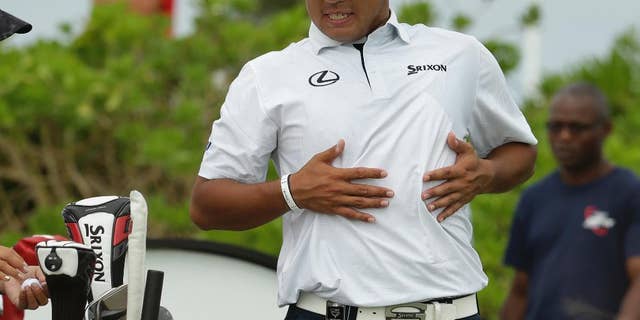 Hideki Matsuyama, of Japan, stretches before teeing off on the first hole during the final round at the Hero World Challenge golf tournament, Sunday, Dec. 4, 2016, in Nassau, Bahamas.
