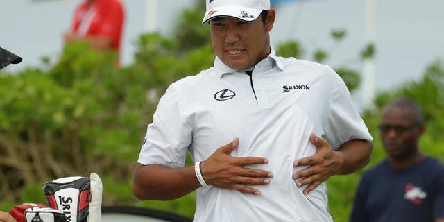 Hideki Matsuyama, of Japan, stretches before teeing off on the first hole during the final round at the Hero World Challenge golf tournament, Sunday, Dec. 4, 2016, in Nassau, Bahamas.