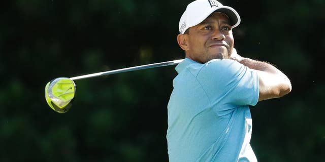Tiger Woods follows his shot from the 11th tee during the second round of The Players Championship golf tournament Friday, May 8, 2015, in Ponte Vedra Beach, Fla. (AP Photo/Lynne Sladky)