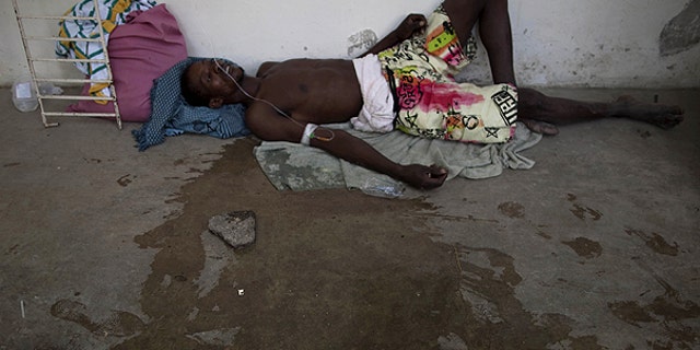 Oct. 22: A man suffering from cholera symptoms lies on the floor of the hospital in Marchand Dessalines, Haiti.