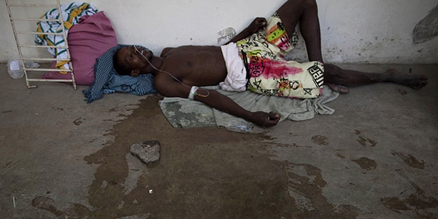 Oct. 22: A man suffering from cholera symptoms lies on the floor of the hospital in Marchand Dessalines, Haiti.