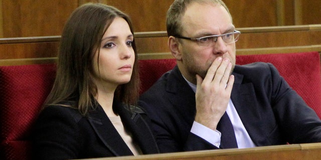 ADDS THAT THE OPPOSITION LATER SAID THAT HE WAS BEING QUESTIONED AND IS NOT ARRESTED FILE - In this Nov. 8, 2013 file photo, Eugenia Tymoshenko, daughter of imprisoned former Ukrainian Prime Minister Yulia Tymoshenko,left, and Serhiy Vlasenko, the lawyer of former Prime Minister Yulia Tymoshenko watch a parliament session in Kiev, Ukraine. Opposition leader Arseniy Yatsenyuk told a parliamentary committee hearing on Monday Nov. 11, 2013, that he has received a text message from Serhiy Vlasenko saying that he has been arrested, according to Yatsenyuk’s spokeswoman Olha Lappo. Tymoshenko’s office could not immediately confirm the arrest. Yatsenyuk said later that the opposition was reassured by a top prosecutor that Vlasenko is not arrested but is being questioned.(AP Photo/Sergei Chuzavkov, File)