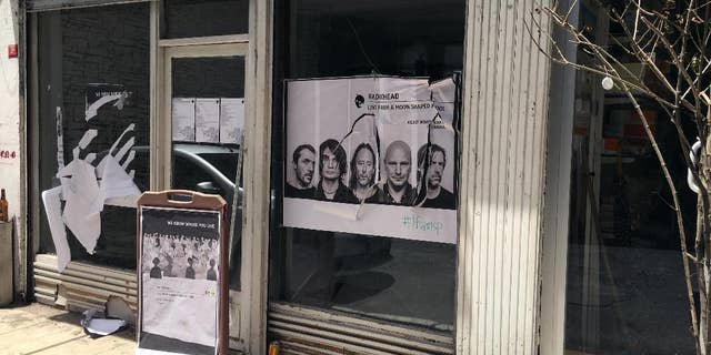 A ripped up poster advertising the streaming event of Radiohead's new album, at a record shop, in Istanbul, Saturday, June 18, 2016. Turkish media report a mob of 20 assailants carrying sticks and bottles attacked Radiohead fans who had gathered at a record store in Istanbul to listen to the band's new album. The private Dogan news agency reported Saturday that one person was wounded in the incident Friday at the Velvet Indieground record shop. (AP Photo/Dominique Soguel)