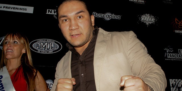 In this May 27, 2010 photo, Mexican wrestler Pedro Aguayo Ramirez, known as Hijo del Perro Aguayo, poses for photographers at the start of a news conference in Mexico City. Ramirez, the son of a wrestling legend in the country, died early Saturday March 21, 2015, from a hit suffered in the ring in Tijuana, the Baja California state prosecutor's office said. (AP Photo/Enrique Ordonez-CUARTOSCURO.COM) MEXICO OUT - NO PUBLICAR EN MEXICO - MANDATORY CREDIT - CREDITO OBLIGATORIO