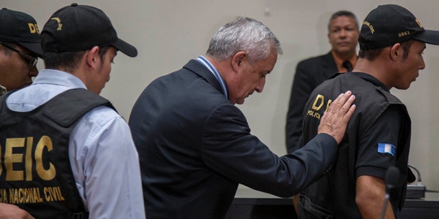 Former President of Guatemala Otto Perez Molina, center, is escorted by police detectives on his way to jail, after a court hearing where he faces corruption charges, in Guatemala City, Thursday, Sept. 3, 2015. Perez Molina was detained overnight before the hearing was to resume Friday morning. Judge Miguel Angel Galvez cited a need to âensure the continuity of the hearingâ and guarantee the former presidentâs personal safety.  (AP Photo/Luis Soto)