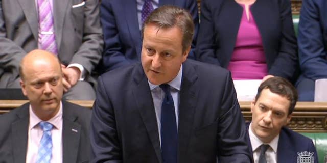In this image taken from House of Commons TV, Britain's Prime Minister David Cameron makes a statement to the House of Commons over his personal finances, in London, Monday, April 11, 2016, with Chancellor of the Exchequer George Osborne, right, and senior Conservative Member of Parliament Chris Grayling, left. Under mounting pressure to reveal his financial background after days of damaging headlines, Cameron is trying to restore his government’s shaken reputation for competence with a statement in the House of Commons. (House of Commons TV / PA via AP) House of Commons logo bottom right from source.